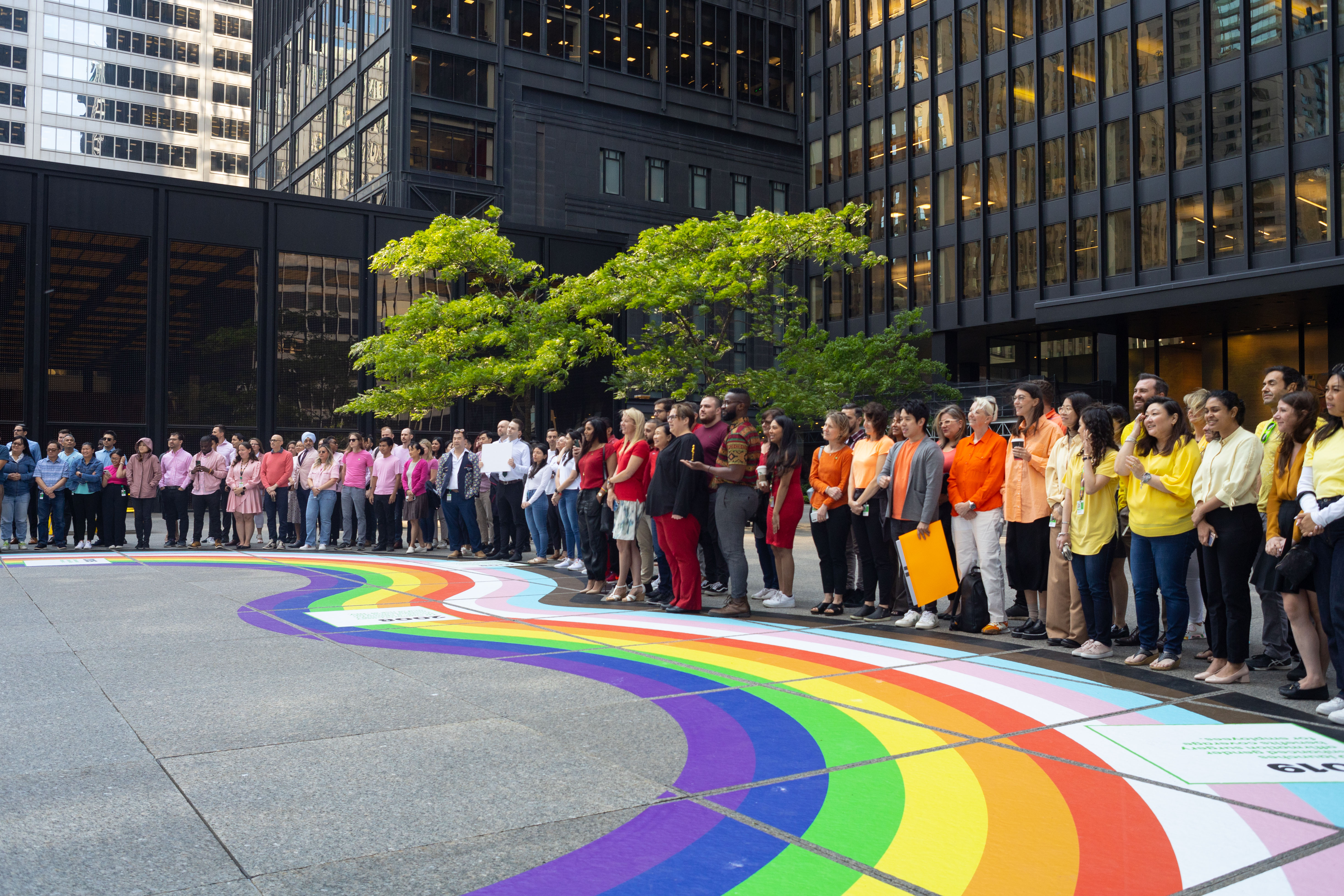 Employees celebrate pride by wearing different coloured t-shirts. 