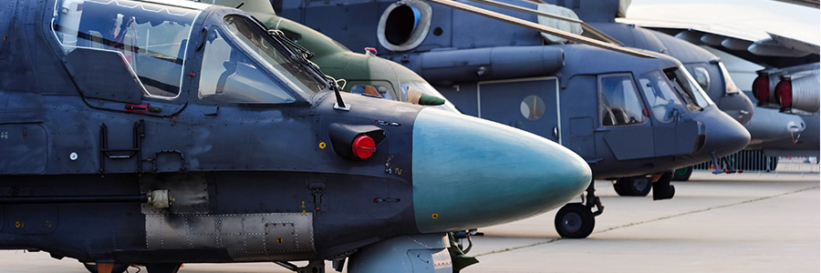 A row of grounded military helicopters. 