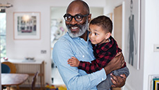 A man holds a child in his arms. 